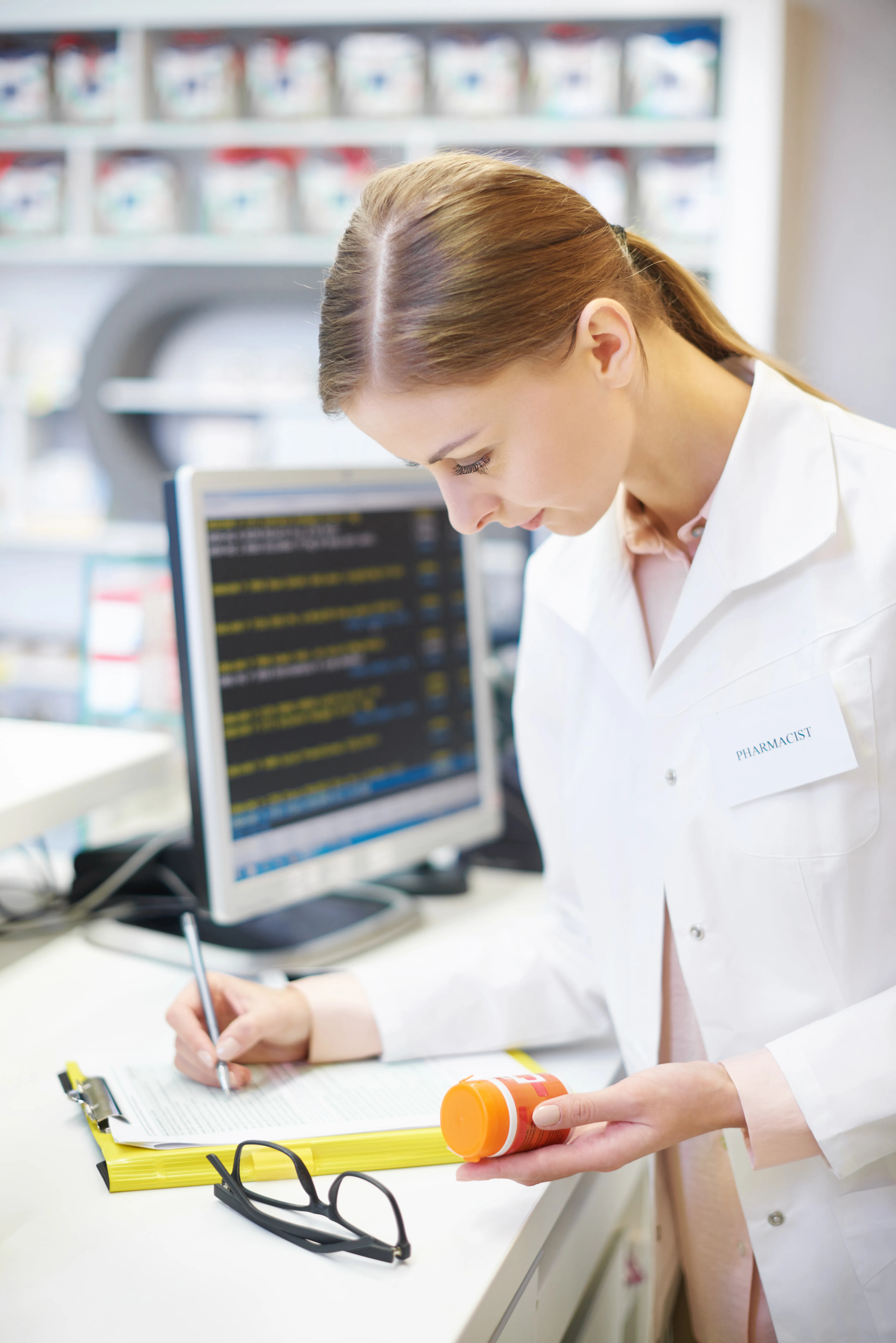 Doctor analyzing treatment plans and medication data with PharmCRM healthcare management platform.